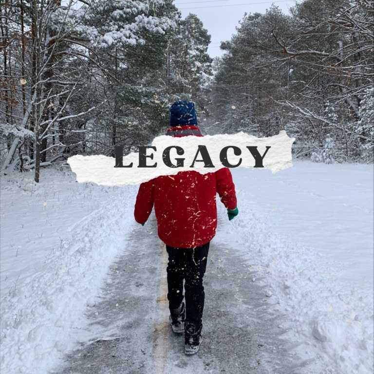 photo of a man walking on a trail with the snow and the word legacy across the photo