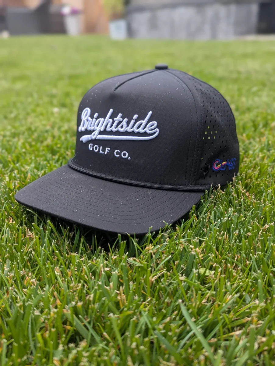 Black Golf Hat Sitting on Green Grass
